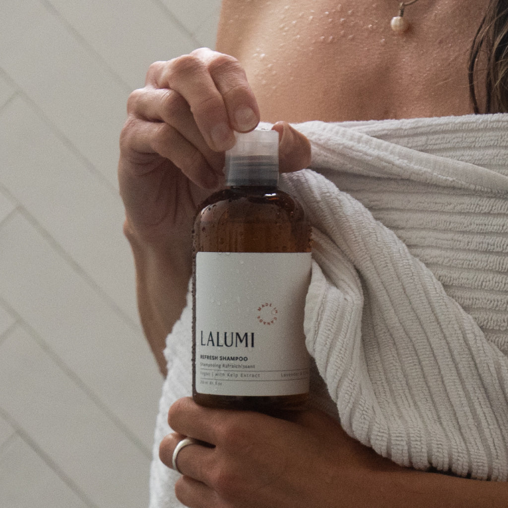 Image of woman holding Lalumi Refresh Shampoo in Shower